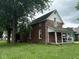Charming brick home with a covered front porch and a spacious yard, offering classic appeal at 590 W Washington St, Martinsville, IN 46151