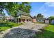 Brick home features a wrap around porch, graveled driveway and a detached red garage at 590 W Washington St, Martinsville, IN 46151