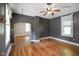Living room with wood floors, grey walls, white trim, ceiling fan, and arched doorway at 590 W Washington St, Martinsville, IN 46151