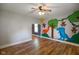 Bright and spacious living room with hardwood floors and a whimsical mural at 590 W Washington St, Martinsville, IN 46151