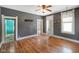Open living room with wood floors, grey walls, white trim, and ceiling fan at 590 W Washington St, Martinsville, IN 46151