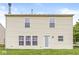 Back of home with large lawn, and view of fenced in neighbor's yard at 6259 Teacup Dr, Indianapolis, IN 46235