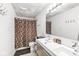 Bathroom with a modern double sink vanity and a shower tub with a decorative curtain at 6259 Teacup Dr, Indianapolis, IN 46235