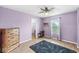 Inviting bedroom with a hardwood floor, fan, and natural light from the large window at 6259 Teacup Dr, Indianapolis, IN 46235
