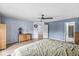 Spacious bedroom featuring a ceiling fan, light wood floors, and an ensuite bathroom at 6259 Teacup Dr, Indianapolis, IN 46235