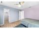 Comfortable bedroom featuring hardwood floors, ceiling fan, and access to a walk-in closet at 6259 Teacup Dr, Indianapolis, IN 46235
