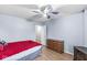 Bright bedroom featuring neutral walls, hardwood floors, fan, and closet access at 6259 Teacup Dr, Indianapolis, IN 46235