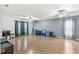 Bonus room featuring hardwood floors, curtains, and two ceiling fans at 6259 Teacup Dr, Indianapolis, IN 46235
