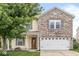 Inviting two-story home featuring a brick facade, attached two-car garage, and a well-maintained lawn at 6259 Teacup Dr, Indianapolis, IN 46235