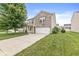 Inviting two-story home with a brick and siding exterior, well-kept lawn, and a wide driveway at 6259 Teacup Dr, Indianapolis, IN 46235