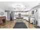 Well-lit kitchen featuring stainless steel appliances, a stone-clad island, and ample cabinet space at 6259 Teacup Dr, Indianapolis, IN 46235
