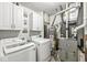 Bright laundry room featuring a modern washer and dryer, storage cabinets, water heater and furnace at 6259 Teacup Dr, Indianapolis, IN 46235