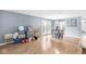 Open-concept living room with wood flooring, neutral walls, and ample natural light at 6259 Teacup Dr, Indianapolis, IN 46235