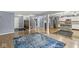 Open concept living room featuring hardwood floors, stairs, kitchen, and stainless steel appliances at 6259 Teacup Dr, Indianapolis, IN 46235
