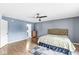 Main bedroom featuring hardwood floors, windows, and a ceiling fan at 6259 Teacup Dr, Indianapolis, IN 46235
