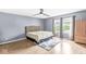 Main bedroom featuring hardwood floors, windows, curtains, and a ceiling fan at 6259 Teacup Dr, Indianapolis, IN 46235