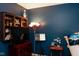 Cozy bedroom featuring a wall-mounted shelf, stylish floor lamp, and classic music stand at 6585 Dunsdin Dr, Plainfield, IN 46168