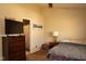 A well-lit bedroom featuring a bed, dresser, and doorway to the en-suite bathroom at 6585 Dunsdin Dr, Plainfield, IN 46168