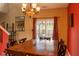 Dining area features stylish curtains, a bright window and a dark wooden table at 6585 Dunsdin Dr, Plainfield, IN 46168