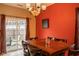 Dining area with a large window, decorative lighting, and a wooden dining table at 6585 Dunsdin Dr, Plainfield, IN 46168