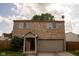 Charming two-story brick home with an attached garage and a well-manicured lawn, perfect for a Gathering at 6585 Dunsdin Dr, Plainfield, IN 46168