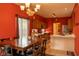 Bright kitchen and dining area with wooden cabinets, tiled floors, and a view of the outdoors through the window at 6585 Dunsdin Dr, Plainfield, IN 46168