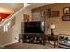 Cozy Gathering room with a large TV, a media console, and various Gathering photos adorning the walls at 6585 Dunsdin Dr, Plainfield, IN 46168