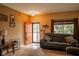 Cozy living room with a comfortable sofa, a bright red door and window with blinds for natural light at 6585 Dunsdin Dr, Plainfield, IN 46168