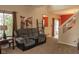 Relaxing living space featuring reclining furniture, a decorative painting, and a view towards a sliding glass door at 6585 Dunsdin Dr, Plainfield, IN 46168