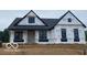 Modern farmhouse exterior elevation with black windows and roof during construction phase at 6638 Dogwood Dr, McCordsville, IN 46055