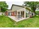 Backyard showing the patio and sunroom with floor-to-ceiling windows at 6965 Steinmeier W Dr, Indianapolis, IN 46220