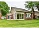 Home exterior featuring a sunroom with floor to ceiling window views and a brick patio at 6965 Steinmeier W Dr, Indianapolis, IN 46220