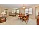 Spacious dining area features a traditional wooden table, matching hutch, and abundant natural light from large windows at 6965 Steinmeier W Dr, Indianapolis, IN 46220