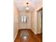 Inviting entryway with a decorative front door, hardwood floors, and stylish lighting at 6965 Steinmeier W Dr, Indianapolis, IN 46220