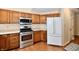 Well-equipped kitchen featuring wood cabinets, stainless steel appliances, and ample counter space at 6965 Steinmeier W Dr, Indianapolis, IN 46220