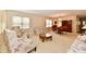 Bright and inviting living room featuring plush floral furniture and a sunlit dining area, perfect for comfortable living at 6965 Steinmeier W Dr, Indianapolis, IN 46220