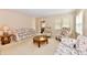 Cozy living room with floral sofas, comfortable armchairs, and a glass-topped coffee table, perfect for relaxation and gatherings at 6965 Steinmeier W Dr, Indianapolis, IN 46220
