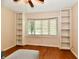 Versatile living room featuring built-in bookshelves and a large bay window, offering both storage and natural light at 6965 Steinmeier W Dr, Indianapolis, IN 46220