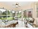 Serene sunroom with lake views, wicker furniture, and expansive sliding doors, seamlessly blending indoor and outdoor living at 6965 Steinmeier W Dr, Indianapolis, IN 46220