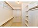 Spacious walk-in closet with built-in shelving and ample hanging space for optimal organization at 6965 Steinmeier W Dr, Indianapolis, IN 46220