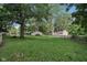 A lush backyard with mature trees surrounding the property, offering privacy at 7141 E Pleasant Run Pkwy S Dr, Indianapolis, IN 46219