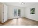 Spacious bedroom with double doors, filled with natural light, highlighting the beautiful floors at 7141 E Pleasant Run Pkwy S Dr, Indianapolis, IN 46219