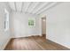 Bedroom features hardwood floors, neutral paint, and natural light at 7141 E Pleasant Run Pkwy S Dr, Indianapolis, IN 46219
