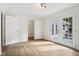 Bedroom features modern lighting, double doors to a private balcony, and walk in closet at 7141 E Pleasant Run Pkwy S Dr, Indianapolis, IN 46219