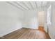 Bedroom features hardwood floors, neutral paint, walk-in closet, and natural light at 7141 E Pleasant Run Pkwy S Dr, Indianapolis, IN 46219