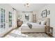 Bright bedroom with a neutral palette, French doors, and sun-drenched hardwood floors at 7141 E Pleasant Run Pkwy S Dr, Indianapolis, IN 46219