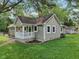 Ranch-style home with a covered front porch, showcasing its neutral siding and well-maintained landscaping in a suburban setting at 7141 E Pleasant Run Pkwy S Dr, Indianapolis, IN 46219
