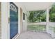 Charming front porch with a white railing offers a clear view of the street and a welcoming entrance at 7141 E Pleasant Run Pkwy S Dr, Indianapolis, IN 46219