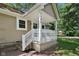 Inviting front porch featuring white railing and pillars, complemented by neutral siding and clear house number display at 7141 E Pleasant Run Pkwy S Dr, Indianapolis, IN 46219