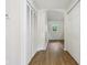 Bright hallway with vinyl floors, closet space and a window providing natural light at 7141 E Pleasant Run Pkwy S Dr, Indianapolis, IN 46219